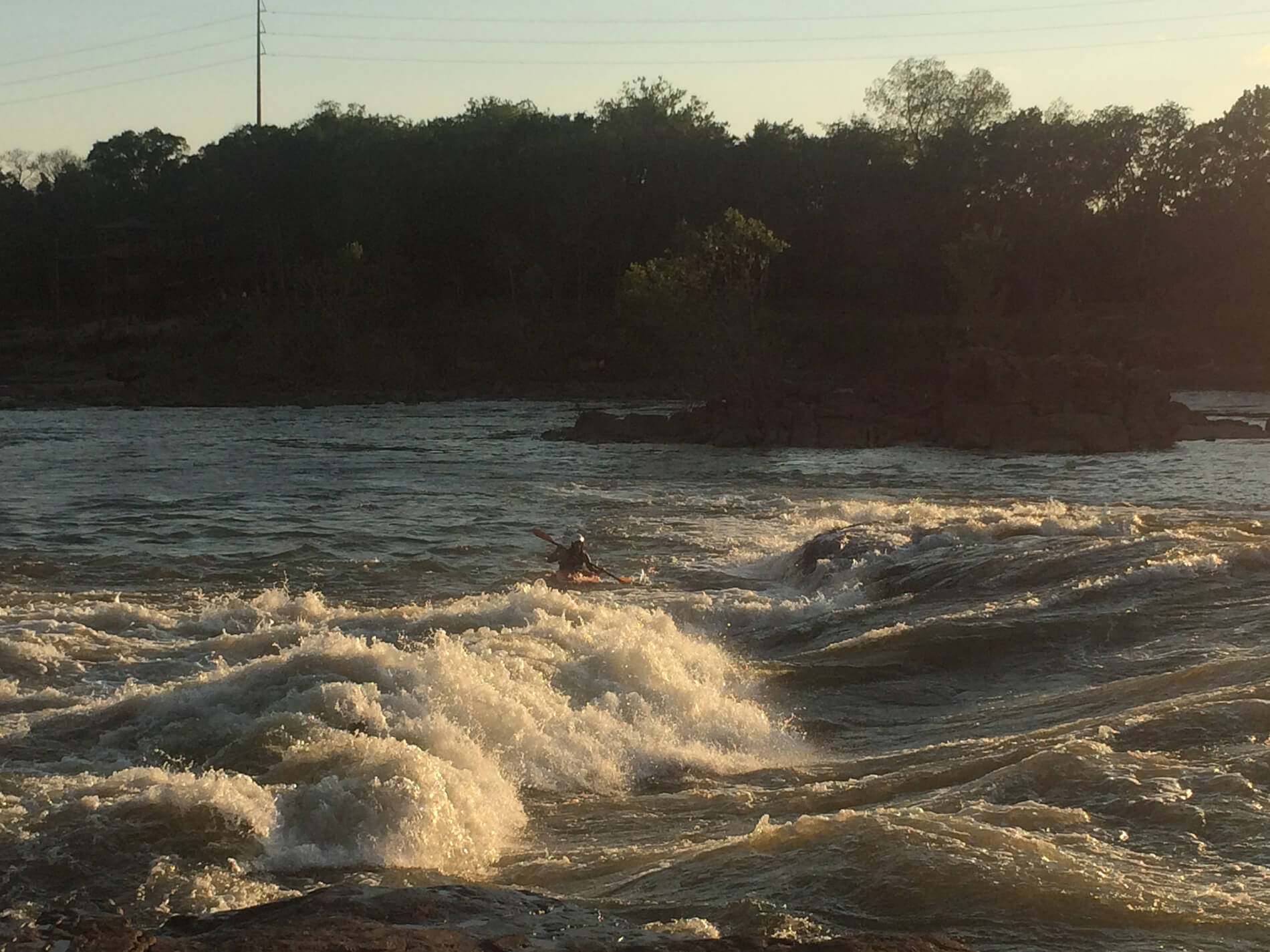 (A lone kayaker in the late summer afternoon on the Chattahoochee in Columbus)