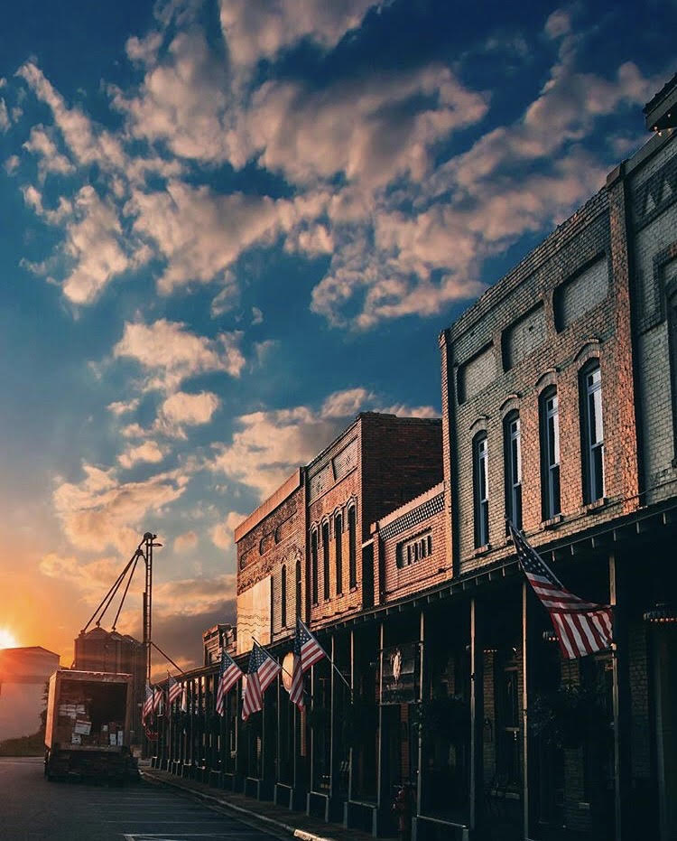 Images shows the Chattahoochee River and historic columbus, GA buildings. 